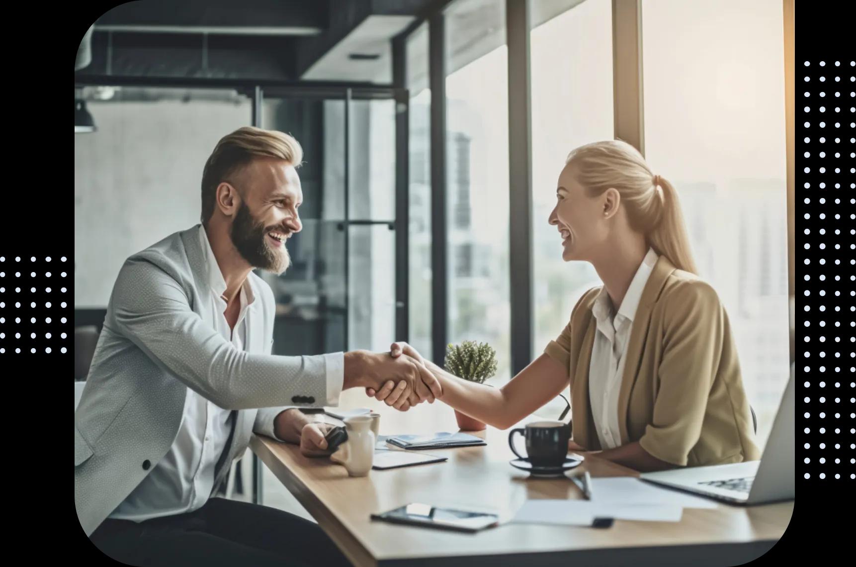 Key Account Manager podający rękę partnerce przy biurku